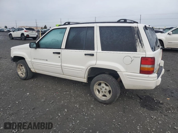 1998 Jeep Grand Cherokee Laredo with VIN 1J4GZ48S1WC165851, listed as a Copart auction lot 84110044 with 306,484 mi miles and Salvage Title. Bid and sale history available at carsss.com. Image 2.