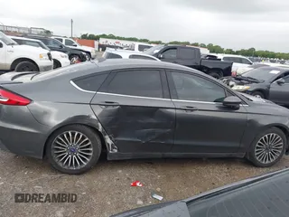 2020 Ford Fusion SE z VIN 3FA6P0HD5LR198744, wystawiony jako IAAI lot #42177820 z przebiegiem 97 520 mil mil oraz . Historia ofert i sprzedaży dostępna na DreamBid. Obrazek 13.