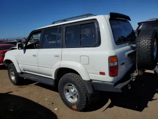 1997 Toyota Land Cruiser with VIN JT3HJ85J2V0180979, listed as a Copart auction lot 73216714 with 239,444 mi miles and Salvage Title. Bid and sale history available at carsss.com. Image 2.