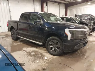 2023 Ford F-150 Lightning Pro with VIN 1FT6W1EV0PWG08563, listed as a IAAI auction lot 41567009 with 22,717 mi miles. Bid and sale history available at carsss.com. Image 1.