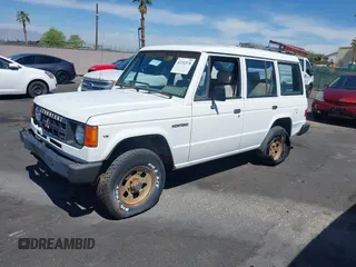 1990 Mitsubishi Montero z VIN JA4GJ31S0LJ009870, wystawiony jako IAAI lot #42192378 z przebiegiem 200 028 mil mil oraz . Historia ofert i sprzedaży dostępna na DreamBid. Obrazek 2.