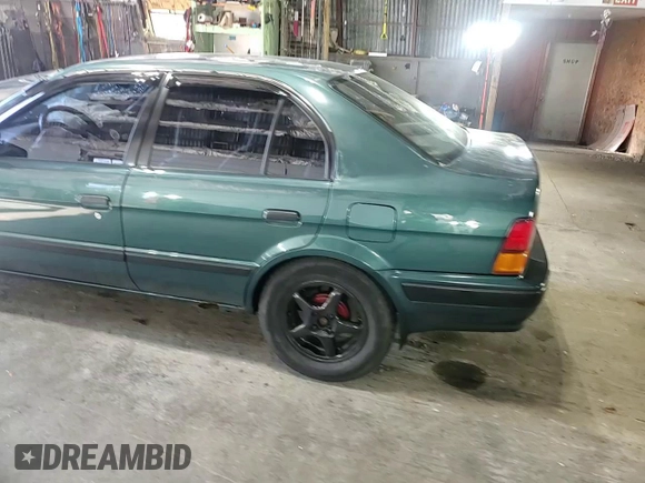 1996 Toyota Tercel DX z VIN JT2BC52L7T7044201, wystawiony jako Copart lot #77190074 z przebiegiem Nie podano mil oraz Szkoda całkowita • Salvage title. Historia ofert i sprzedaży dostępna na DreamBid. Obrazek 10.