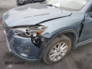 2016 Mazda CX-5 Touring z VIN JM3KE2CY2G0699138, wystawiony jako IAAI lot #42153228 z przebiegiem 144 191 mil mil oraz . Historia ofert i sprzedaży dostępna na DreamBid. Obrazek 6.