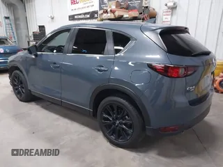 2021 Mazda CX-5 Touring z VIN JM3KFBCM4M0459465, wystawiony jako IAAI lot #41059836 z przebiegiem 74 645 mil mil oraz . Historia ofert i sprzedaży dostępna na DreamBid. Obrazek 3.