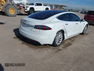 2020 Tesla Model S Long Range with VIN 5YJSA1E23LF360441, listed as a IAAI auction lot 41312865 with 68,967 mi miles and . Bid and sale history available at DreamBid. Image 4.