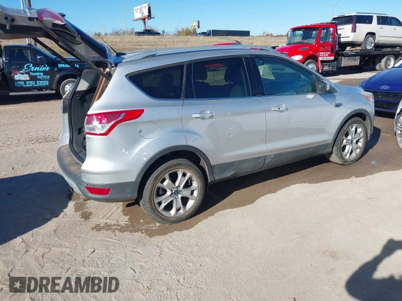 2014 Ford Escape Titanium with VIN 1FMCU0JX7EUC59643, listed as a IAAI auction lot 41082952 with 143,899 mi miles. Bid and sale history available at carsss.com. Image 4.