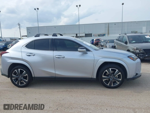 2023 Lexus UX 250h Premium z VIN JTHP6JBH5P2145912, wystawiony jako IAAI lot #42401353 z przebiegiem 14 252 mil mil oraz . Historia ofert i sprzedaży dostępna na DreamBid. Obrazek 13.
