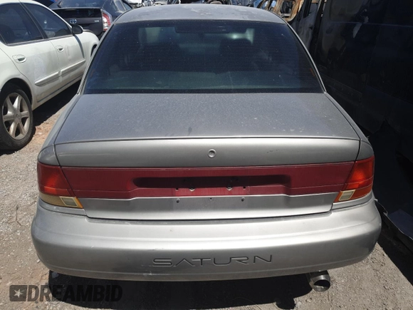 1999 Saturn SL z VIN 1G8ZK5271XZ316032, wystawiony jako Copart lot #50663015 z przebiegiem 164 288 mil mil oraz Nie do naprawy • Non repairable. Historia ofert i sprzedaży dostępna na DreamBid. Obrazek 6.