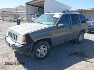 1997 Jeep Grand Cherokee Laredo with VIN 1J4GZ58S3VC603239, listed as a IAAI auction lot 42593915 with 295,696 mi miles and . Bid and sale history available at DreamBid. Image 2.