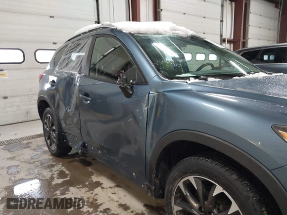 2016 Mazda CX-5 Grand Touring z VIN JM3KE4DY9G0714468, wystawiony jako IAAI lot #41860956 z przebiegiem 114 481 mil mil oraz . Historia ofert i sprzedaży dostępna na DreamBid. Obrazek 6.