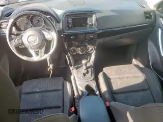 2014 Mazda CX-5 Touring with VIN JM3KE2CY1E0323298, listed as a Copart auction lot 50421685 with 214,739 mi miles and Salvage Title. Bid and sale history available at DreamBid. Image 8.