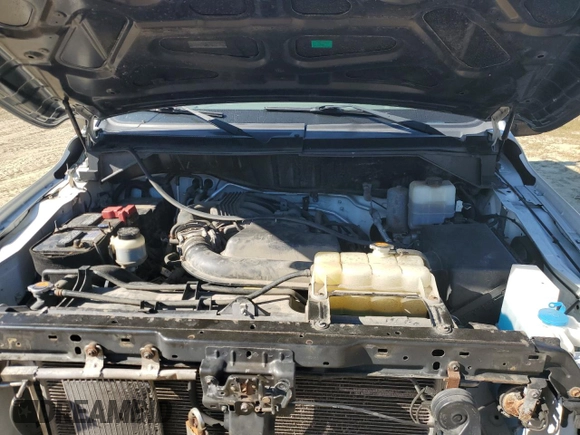 2018 Nissan NV Cargo S z VIN 1N6BF0KM4JN809929, wystawiony jako Copart lot #70578344 z przebiegiem 141 309 mil mil oraz Szkoda całkowita • Salvage title. Historia ofert i sprzedaży dostępna na DreamBid. Obrazek 13.
