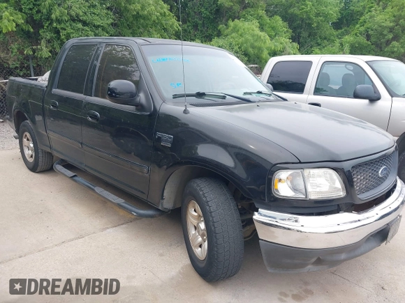 2002 Ford F-150 XLT with VIN 1FTRW07692KE26387, listed as a IAAI auction lot 42079023 with 218,876 mi miles. Bid and sale history available at carsss.com. Image 1.