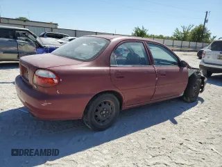 2001 Kia Sephia z VIN KNAFB121115074609, wystawiony jako Copart lot #72346144 z przebiegiem 88 400 mil mil oraz Tytuł czysty. Historia ofert i sprzedaży dostępna na DreamBid. Obrazek 3.