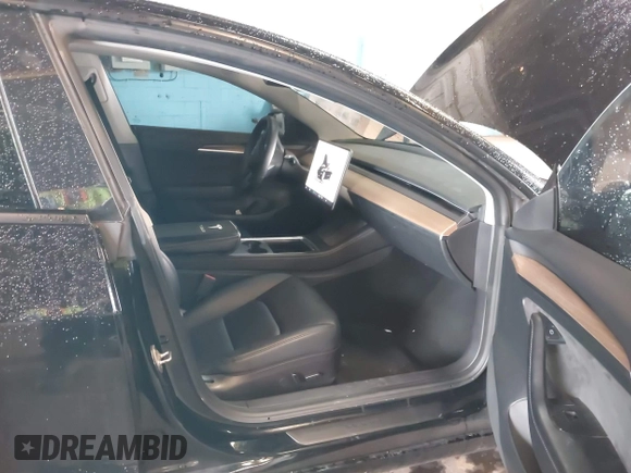 2023 Tesla Model 3 with VIN 5YJ3E1EA5PF396413, listed as a IAAI auction lot 42188639 with 57,717 mi miles and . Bid and sale history available at DreamBid. Image 5.