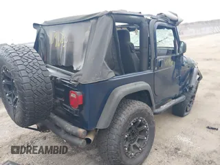2003 Jeep Wrangler X with VIN 1J4FA39S23P300447, listed as a IAAI auction lot 41791733 with 165,576 mi miles. Bid and sale history available at carsss.com. Image 4.