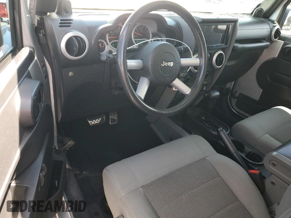 2009 Jeep Wrangler Sahara with VIN 1J4FA54149L708183, listed as a Copart auction lot 65989125 with 133,436 mi miles and Salvage title. Bid and sale history available at DreamBid. Image 8.