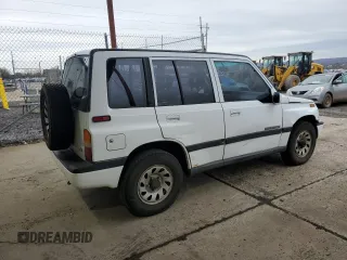 1996 Suzuki Sidekick JX z VIN 2S3TD03V7T6409487, wystawiony jako Copart lot #49977795 z przebiegiem 137 011 mil mil oraz Szkoda całkowita • Salvage title. Historia ofert i sprzedaży dostępna na DreamBid. Obrazek 3.
