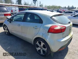 2014 Kia Rio SX with VIN KNADN5A31E6353714, listed as a IAAI auction lot 42127657 with 117,544 mi miles. Bid and sale history available at carsss.com. Image 3.