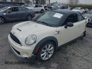 2013 MINI Coupe S with VIN WMWSX3C53DT466648, listed as a IAAI auction lot 41719597 with 106,936 mi miles and . Bid and sale history available at DreamBid. Image 2.