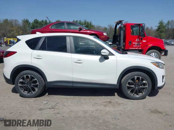 2016 Mazda CX-5 Grand Touring with VIN JM3KE4DY0G0632693, listed as a IAAI auction lot 42123142 with 106,592 mi miles. Bid and sale history available at carsss.com. Image 13.