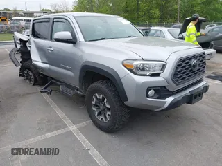 2021 Toyota Tacoma SR z VIN 5TFCZ5AN7MX268521, wystawiony jako IAAI lot #42016699 z przebiegiem 80 176 mil mil oraz . Historia ofert i sprzedaży dostępna na DreamBid. Obrazek 1.
