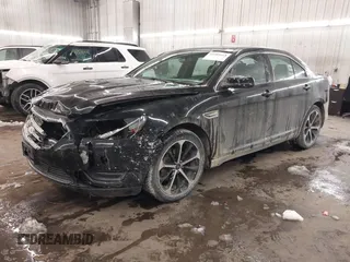 2014 Ford Taurus SEL with VIN 1FAHP2E87EG117653, listed as a IAAI auction lot 41589415 with 125,040 mi miles. Bid and sale history available at carsss.com. Image 2.