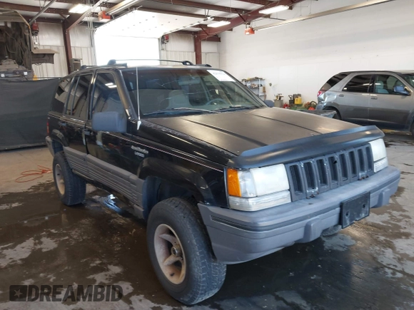 1995 Jeep Grand Cherokee Laredo z VIN 1J4GZ58Y3SC670696, wystawiony jako IAAI lot #42530934 z przebiegiem 165 658 mil mil oraz . Historia ofert i sprzedaży dostępna na DreamBid. Obrazek 1.