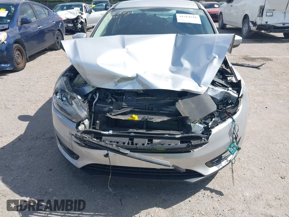 2018 Ford Focus SE z VIN 1FADP3FE3JL220529, wystawiony jako IAAI lot #41564216 z przebiegiem 16 883 mil mil oraz . Historia ofert i sprzedaży dostępna na DreamBid. Obrazek 6.