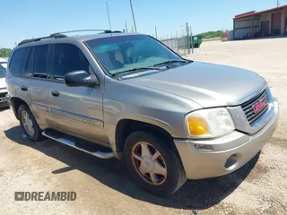 2003 GMC Envoy SLT with VIN 1GKDS13S732150215, listed as a IAAI auction lot 42048209 with 329,719 mi miles. Bid and sale history available at carsss.com. Image 1.