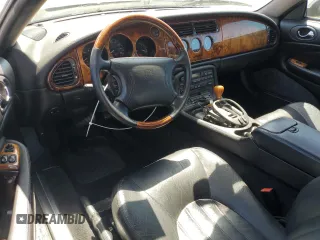 1997 Jaguar XK with VIN SAJGX5740VC014035, listed as a Copart auction lot 53066215 with 140,692 mi miles and Salvage Title. Bid and sale history available at DreamBid. Image 8.