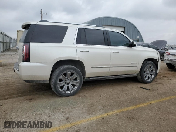 2015 GMC Yukon Denali with VIN 1GKS1CKJ1FR619793, listed as a Copart auction lot 86910314 with 128,559 mi miles and Salvage Title. Bid and sale history available at carsss.com. Image 3.