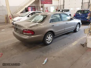 1999 Mazda 626 ES with VIN 1YVGF22C1X5852798, listed as a IAAI auction lot 41736489 with 136,536 mi miles. Bid and sale history available at carsss.com. Image 4.