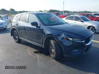 2021 Mazda CX-5 Touring z VIN JM3KFBCM4M1386043, wystawiony jako IAAI lot #42388294 z przebiegiem 52 548 mil mil oraz . Historia ofert i sprzedaży dostępna na DreamBid. Obrazek 1.