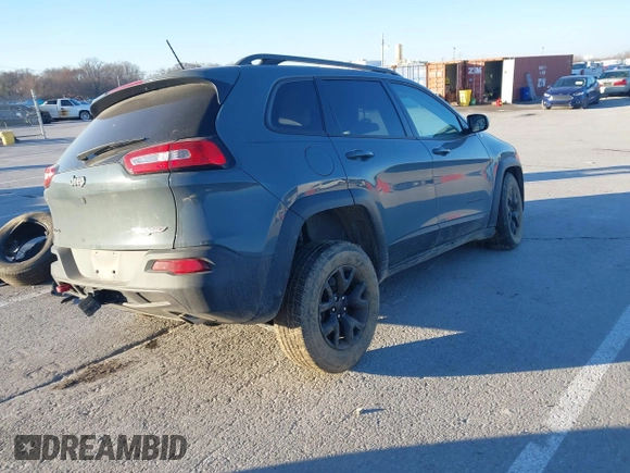 2015 Jeep Cherokee Trailhawk with VIN 1C4PJMBSXFW614416, listed as a IAAI auction lot 41033241 with 112,015 mi miles. Bid and sale history available at carsss.com. Image 4.