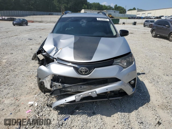 2018 Toyota RAV4 XLE with VIN 2T3WFREVXJW427748, listed as a Copart auction lot 61833055 with 104,057 mi miles and Salvage title. Bid and sale history available at DreamBid. Image 5.