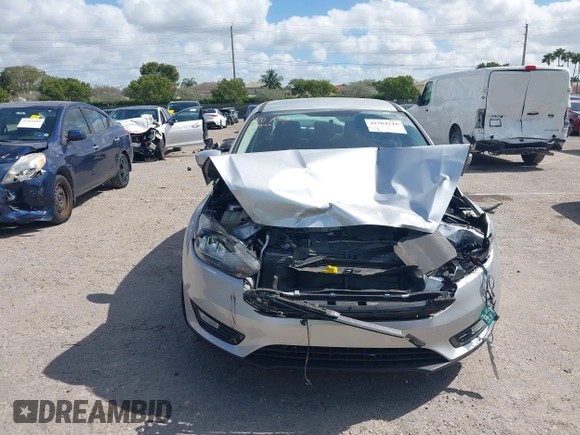 2018 Ford Focus SE z VIN 1FADP3FE3JL220529, wystawiony jako IAAI lot #41564216 z przebiegiem 16 883 mil mil oraz . Historia ofert i sprzedaży dostępna na DreamBid. Obrazek 12.