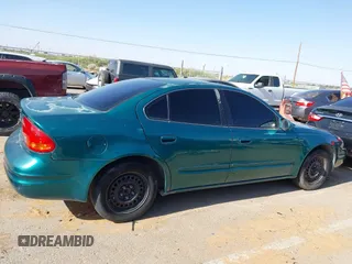 1999 Oldsmobile Alero GL z VIN 1G3NL52T0XC354966, wystawiony jako IAAI lot #42259258 z przebiegiem Nie podano mil oraz . Historia ofert i sprzedaży dostępna na DreamBid. Obrazek 13.