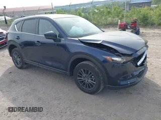 2021 Mazda CX-5 Touring z VIN JM3KFBCMXM0389857, wystawiony jako IAAI lot #42309650 z przebiegiem 49 938 mil mil oraz . Historia ofert i sprzedaży dostępna na DreamBid. Obrazek 1.