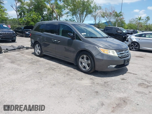 2013 Honda Odyssey Touring with VIN 5FNRL5H96DB068843, listed as a IAAI auction lot 42312176 with 115,804 mi miles and . Bid and sale history available at DreamBid. Image 1.