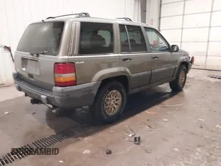 1996 Jeep Grand Cherokee Laredo with VIN 1J4GZ58S5TC182766, listed as a IAAI auction lot 41372356 with 234,390 mi miles. Bid and sale history available at carsss.com. Image 4.