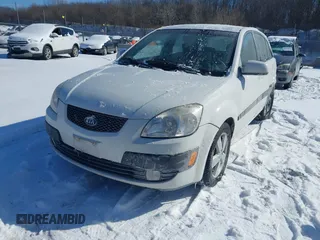 2009 Kia Rio LX with VIN KNADE243196500999, listed as a IAAI auction lot 41582717 with 119,877 mi miles. Bid and sale history available at carsss.com. Image 2.