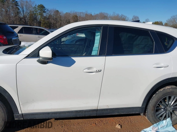 2020 Mazda CX-5 Touring with VIN JM3KFBCM0L0828207, listed as a IAAI auction lot 41305801 with 56,500 mi miles and . Bid and sale history available at DreamBid. Image 14.