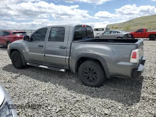 2006 Mitsubishi Raider Duro Cross z VIN 1Z7HC38N86S542959, wystawiony jako Copart lot #57301385 z przebiegiem 149 167 mil mil oraz Tytuł czysty. Historia ofert i sprzedaży dostępna na DreamBid. Obrazek 2.