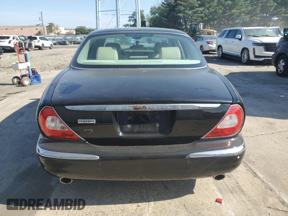 2004 Jaguar XJ with VIN SAJEA71C74SG02851, listed as a Copart auction lot 69056994 with 0 mi miles and Salvage Title. Bid and sale history available at carsss.com. Image 5.