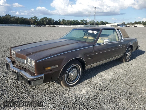 1985 Oldsmobile Toronado Custom Brougham z VIN 1G3EZ57Y6FE321802, wystawiony jako Copart lot #77305454 z przebiegiem 51 559 mil mil oraz Szkoda całkowita • Salvage title. Historia ofert i sprzedaży dostępna na DreamBid. Obrazek 1.