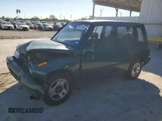 1996 Geo Tracker z VIN 2CNBE1363T6921541, wystawiony jako Copart lot #81647384 z przebiegiem 61 806 mil mil oraz Szkody całkowita. Historia ofert i sprzedaży dostępna na DreamBid. Obrazek 1.