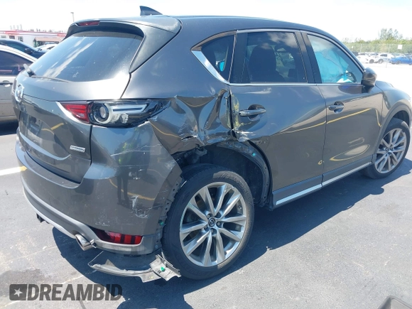 2018 Mazda CX-5 Grand Touring with VIN JM3KFADM8J1310328, listed as a IAAI auction lot 42322780 with 106,378 mi miles and . Bid and sale history available at DreamBid. Image 4.