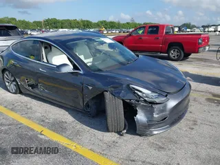 2020 Tesla Model 3 Standard Range Plus with VIN 5YJ3E1EA0LF744046, listed as a IAAI auction lot 41939894 with 102,576 mi miles. Bid and sale history available at carsss.com. Image 1.
