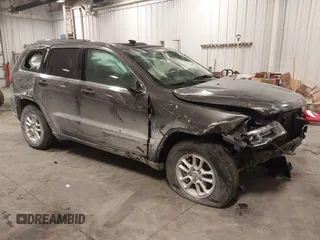 2018 Jeep Grand Cherokee Laredo E with VIN 1C4RJFAG4JC313054, listed as a IAAI auction lot 41469450 with 142,929 mi miles. Bid and sale history available at carsss.com. Image 1.